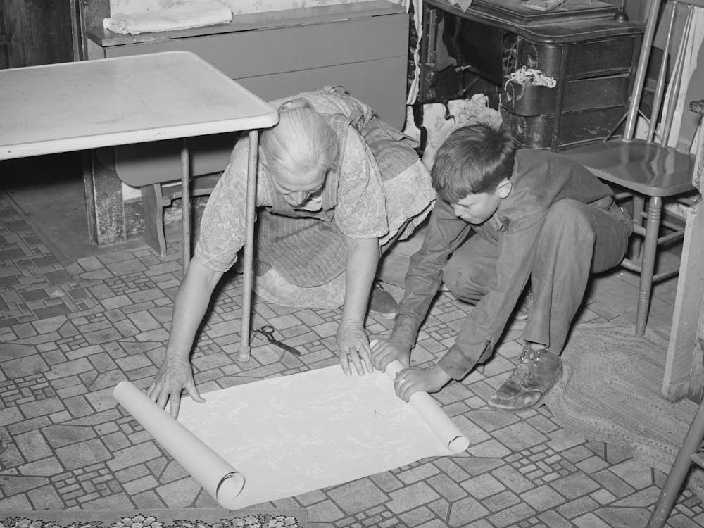 Mrs Hutton And Her Grandson Unrolling Wallpaper For The Kitchen, Pie Town, New Mexico By Russell Lee