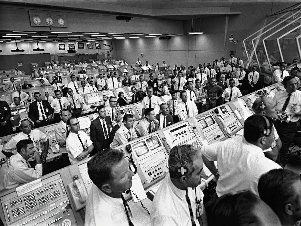 Members Of The Kennedy Space Center Government Industry Team Rise From Their Consoles Within The Launch Control Center To Watch The Apollo 11 Liftoff Through A Window