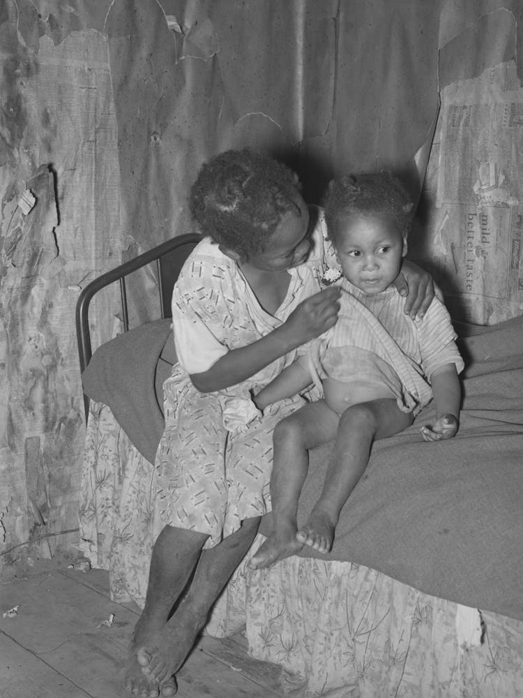 New Madrid County, Missouri, Child Of Sharecropper Wiping Baby S Nose In Cabin By Russell Lee