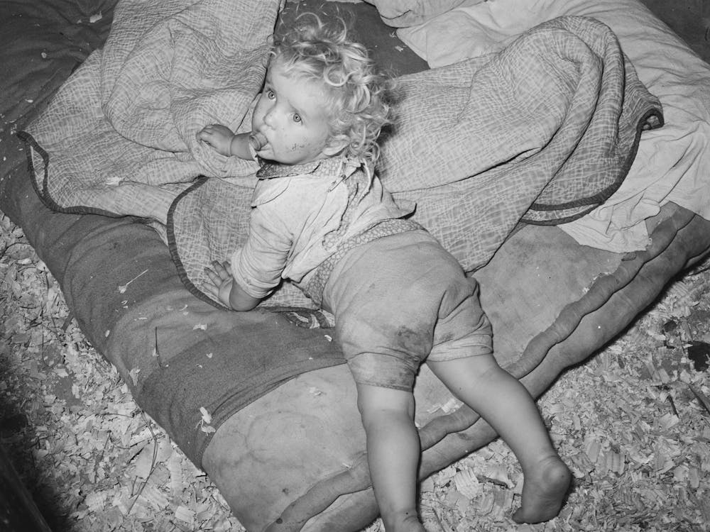 Child Of Migrant Strawberry Picker On Bed In Tent Near Hammond, Louisiana By Russell Lee