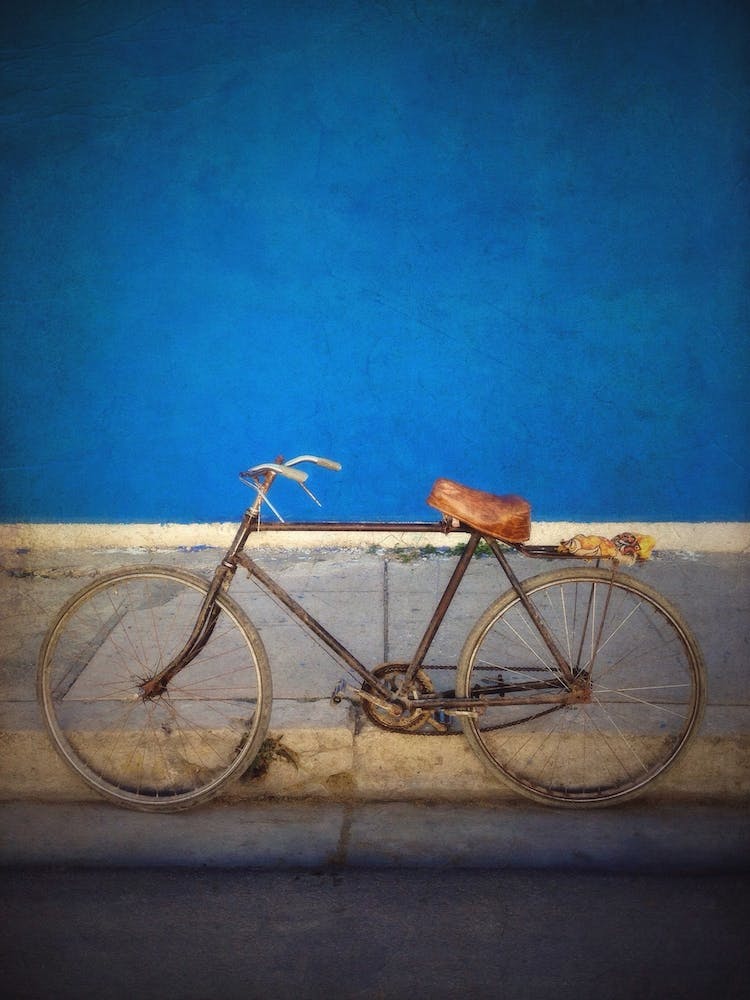Old Bicycle Against Blue Wall