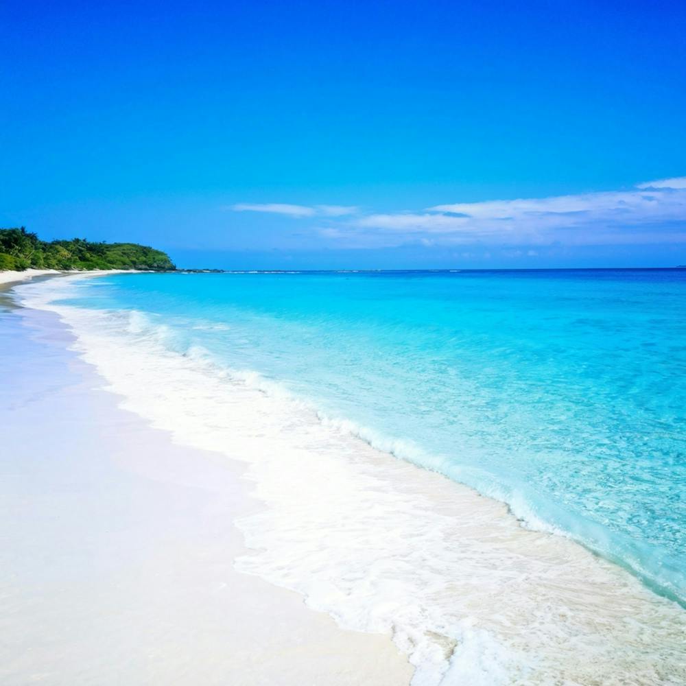 Crystal Clear Turquoise Waters Gently Lap Upon A Sun Drenched Undisturbed Sandy Beach With A Prist (2)