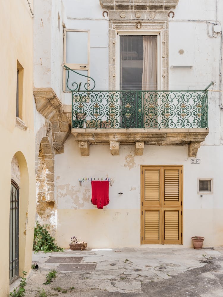 Italian Alleyway With Balcony And Red Shirt