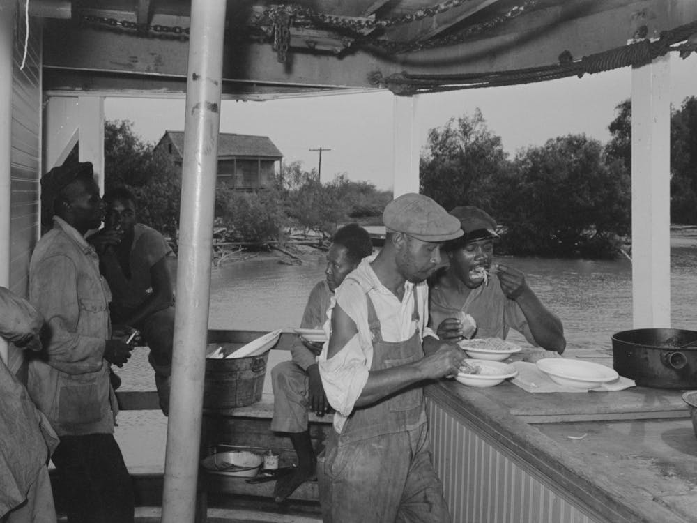 Stevedores Eating On Stern Of Boat, Food Supplied To Crew Consists Almost Entirely Of Carbohydrates With Some Of The