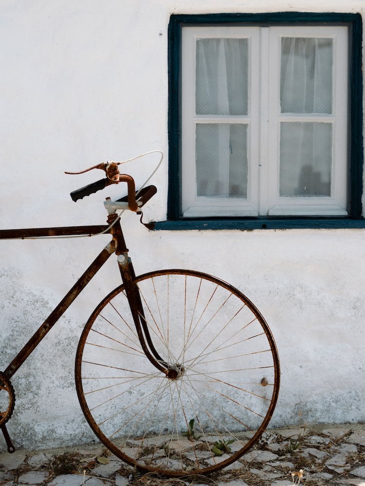 The Bike Against A White Wall In Small Village In Portugal