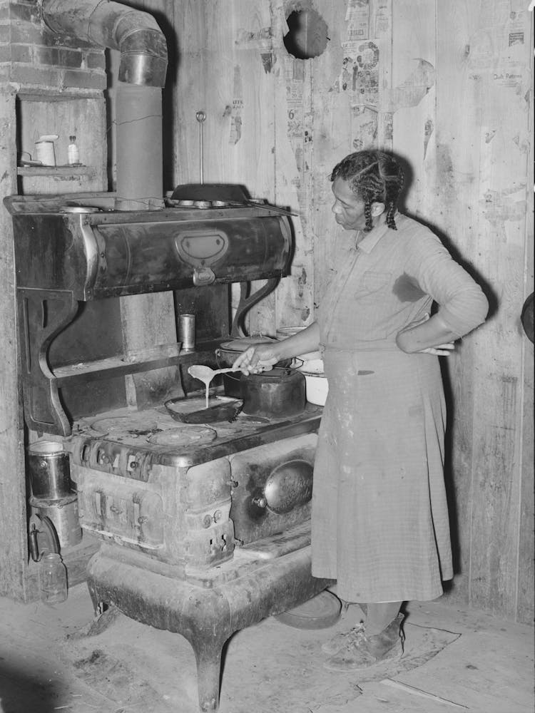 Southeast Missouri Farms, Woman Preparing Gravy In Corner Of Kitchen Sharecropper Cabin By Russell Lee