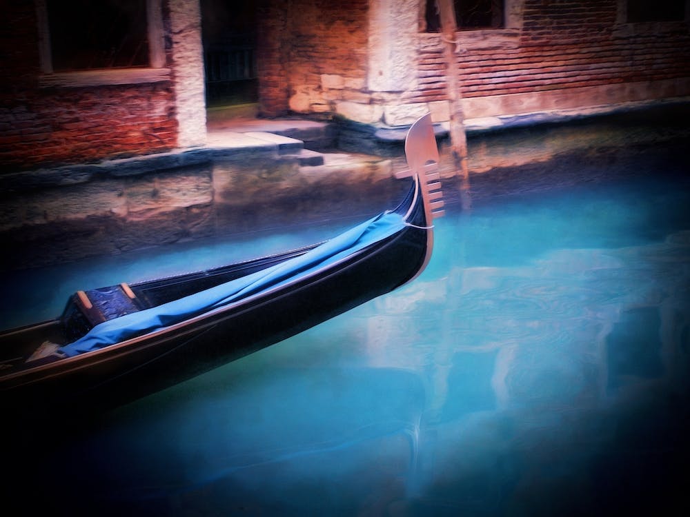 Gliding Gondola On Venetian Canal