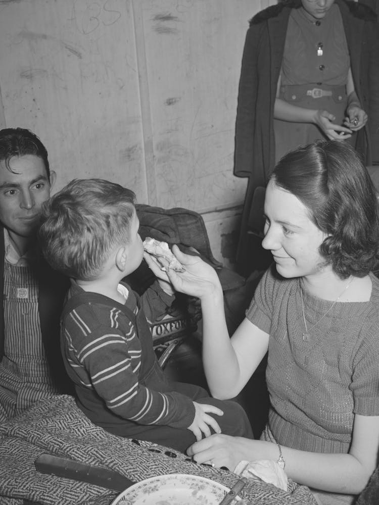 Farm Mother Feeding Pie To Her Son While The Father Watches, Pie Supper In Muskogee County, Oklahoma