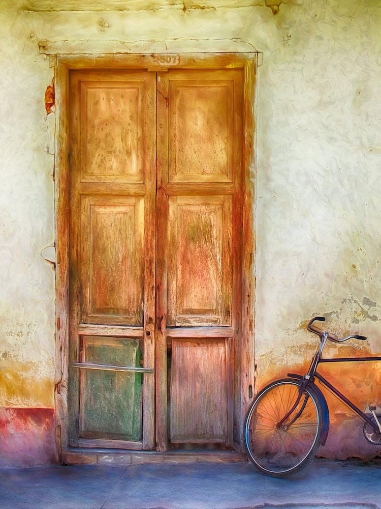Bicycle By Weatherd Door
