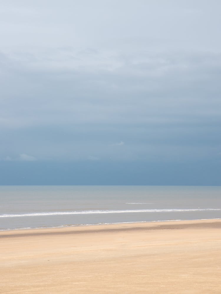 Storm on the horizon with a calm sea in Italy - coastal nature and travel photography by Christa Stroo Photography