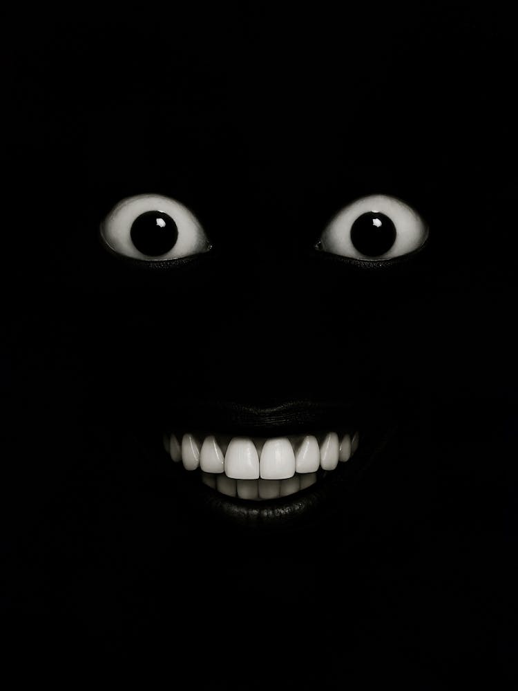 Man Laughing in the Dark Meme Poster – Creepy Eyes and Teeth: A grinning horror in the dark – this minimalist "Man Laughing in the Dark" meme face with wide eyes and sharp teeth stares from a black background. Equal parts creepy, weird, and funny, it’s pe
