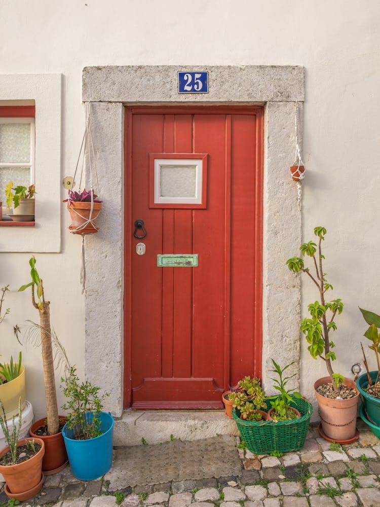 The red door nr. 25 in Alfama, Lisbon, Portugal - summer street and travel photography by Christa Stroo Photography