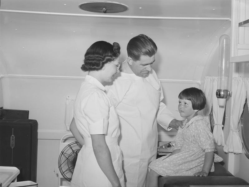 Doctor And Nurse With Little Girl In Trailer Clinic At The Fsa (Farm Security Administration) Migratory Labor Camp 1