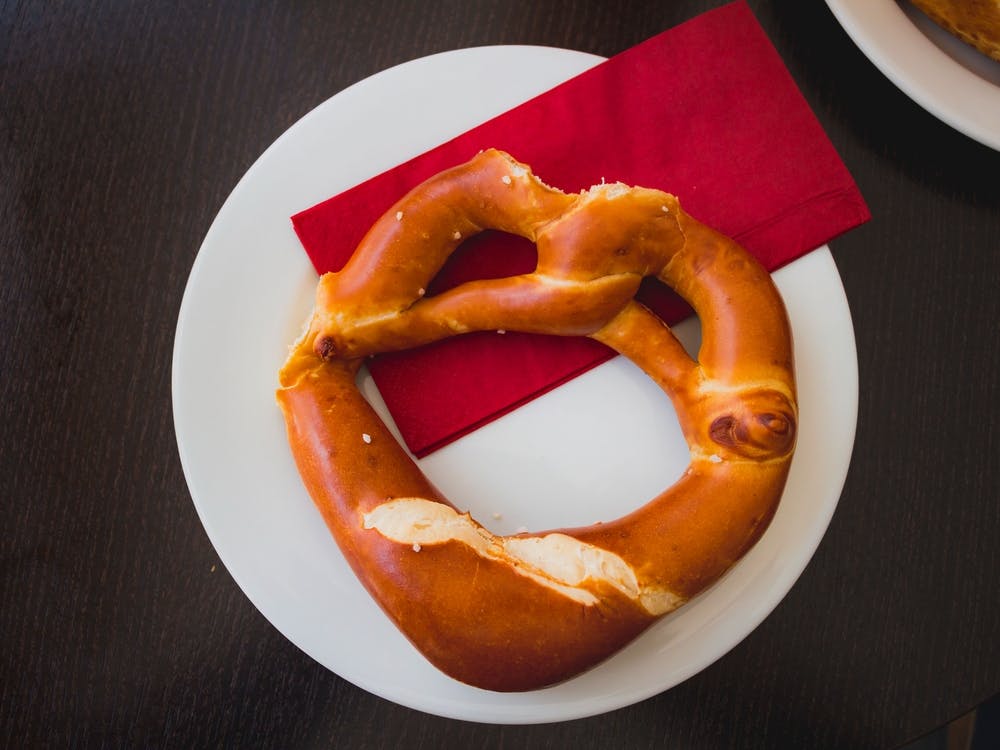 Pretzel Bread On White Plate On Wooden Table