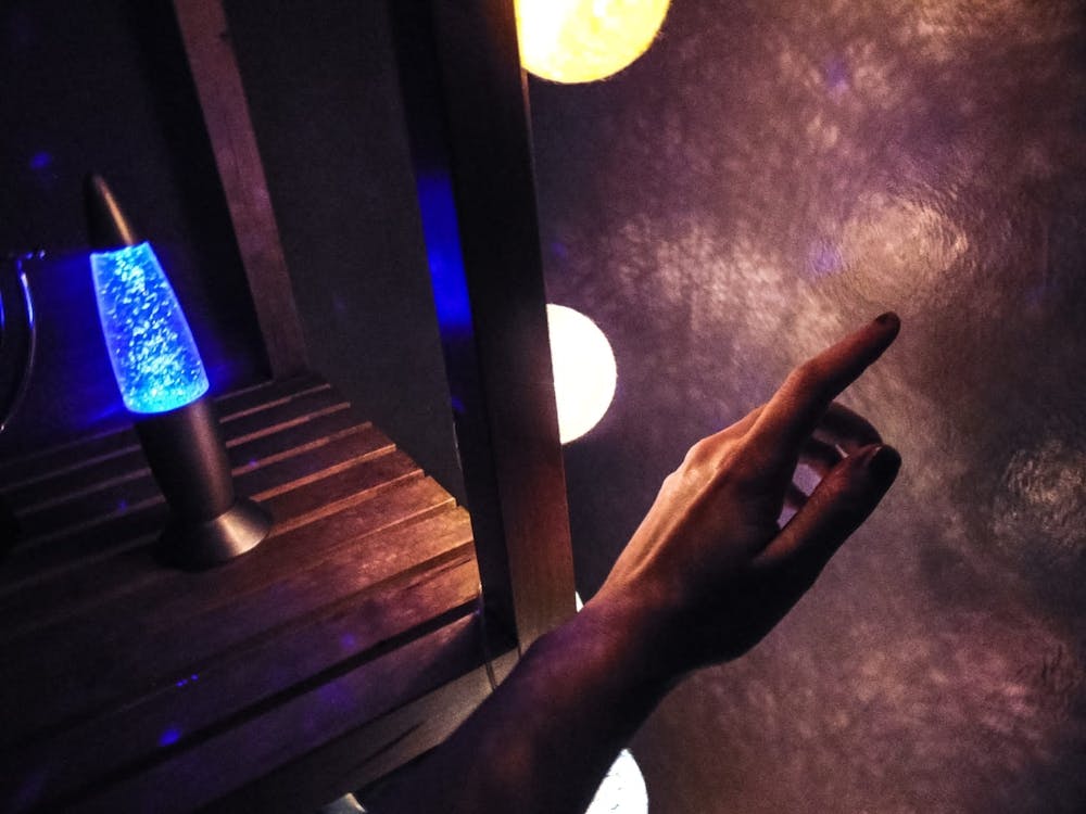 Hand Pointing At A Lamp