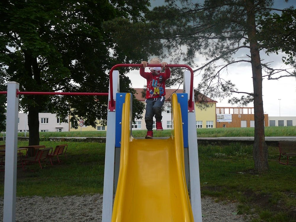 Child On A Playground Slide