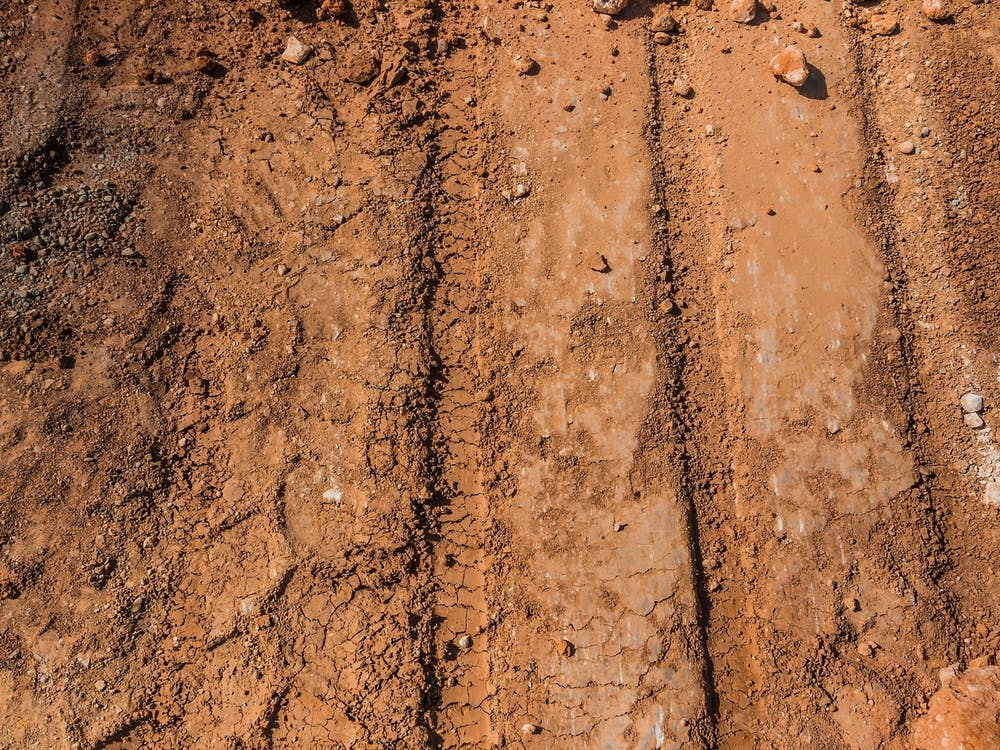 Texture Of Brown Dirt With Tractor Tyre Tracks 2
