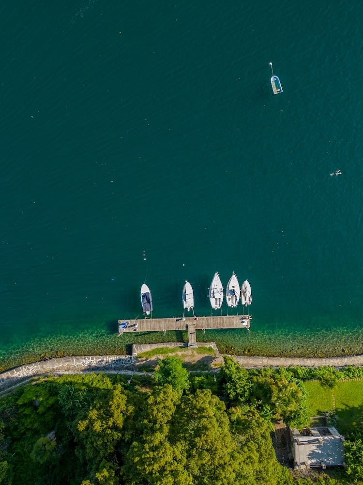 Yachts and Boats Moored in Pier Harbor on lake, Italy.  Aerial photography