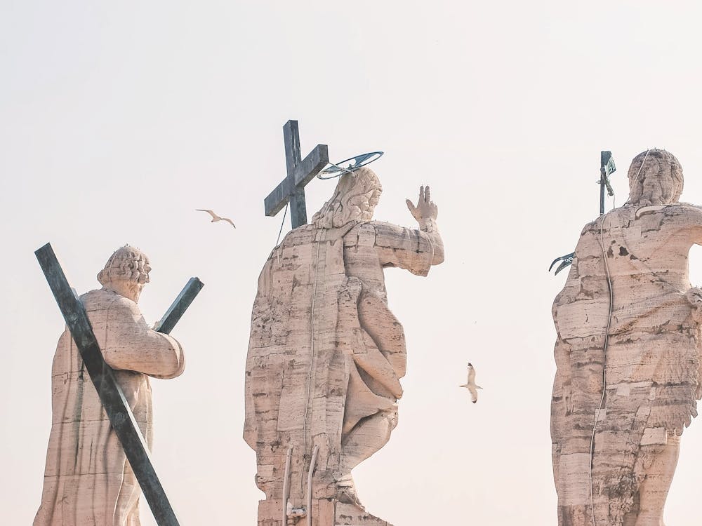 Rome, Italy I Religious statues atop Vatican roof at sunrise with flying seagulls on summer sky with minimalist pastel aesthetic photography capturing the luminous spirit of Roman sacred heritage