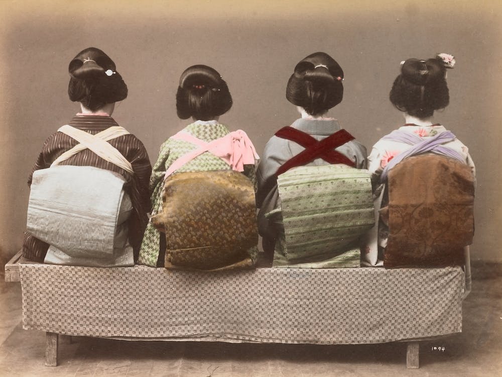Four Japanese Women Seated On A Bench