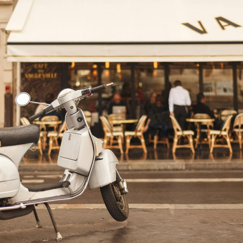 Scooter Outside A Paris Bistro Square