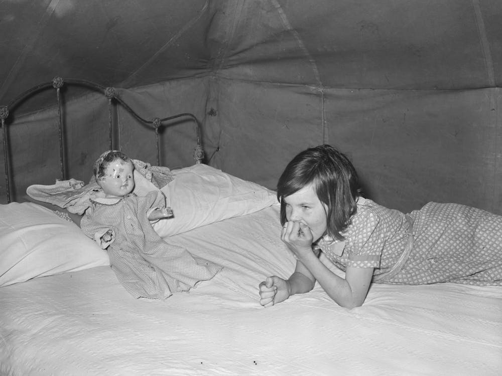 Child Migrant With Doll In Tent Home, Harlingen, Texas By Russell Lee