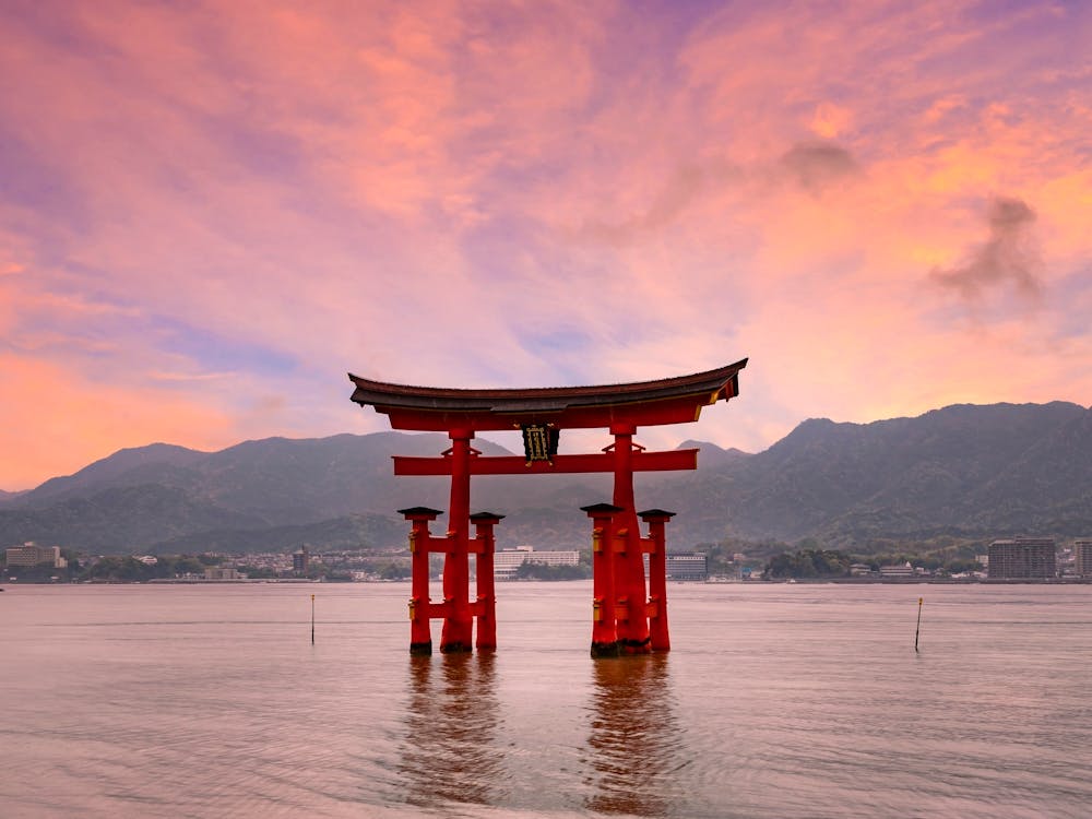 Torii Of Itsukushima Shrine On Miyajima At Sunset
