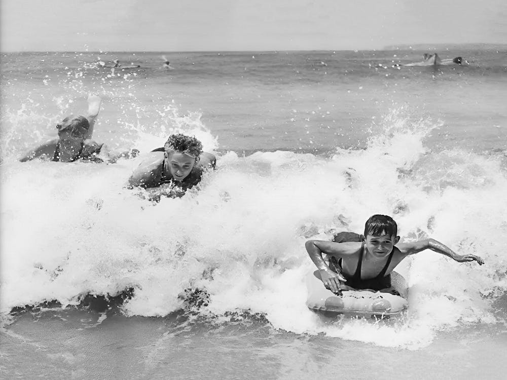 Surfers Catching Waves at the Beach, Vintage Black and White Old Photo