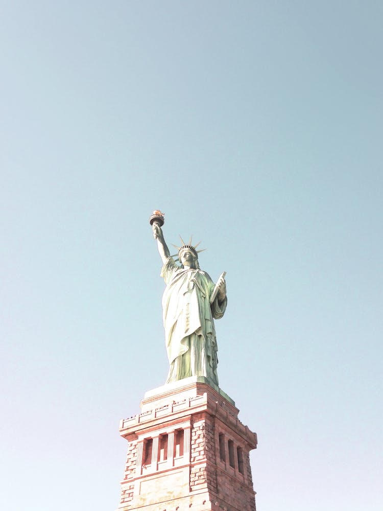 New York, USA I Statue of Liberty neutral pastel with a retro vintage minimalist fine art photography summer aesthetic with brick architecture, symbol of USA on Liberty Island from the Hudson River