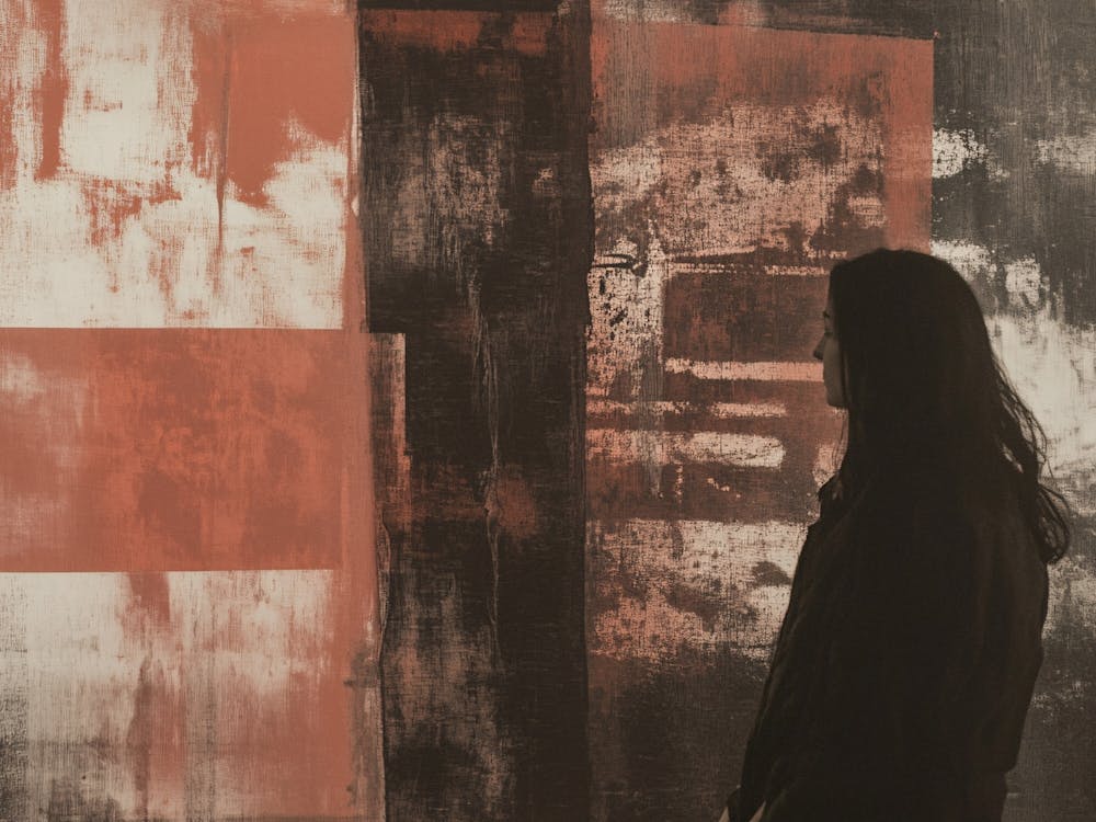 Woman Standing In Front Of Abstract Painting