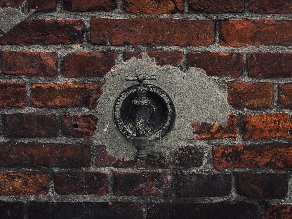 Faucet On A Brick Wall