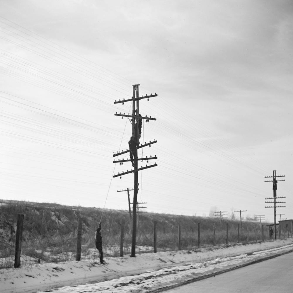 Telephone Linesmen Raising Wires To Keep Them Above The Flood Level