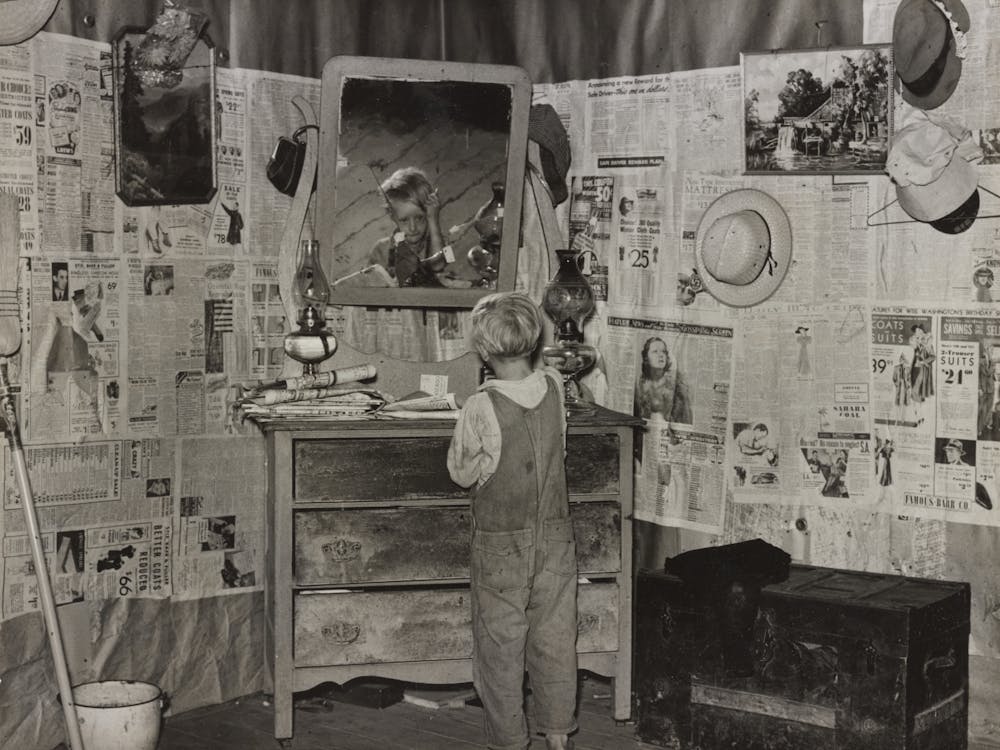 Southeast Missouri Farms, Son Of Sharecropper Combing Hair In Bedroom Of Shack By Russell Lee
