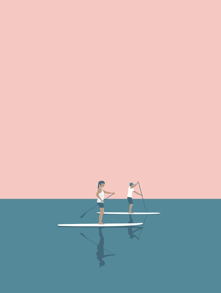 Paddle boarding couple in pink