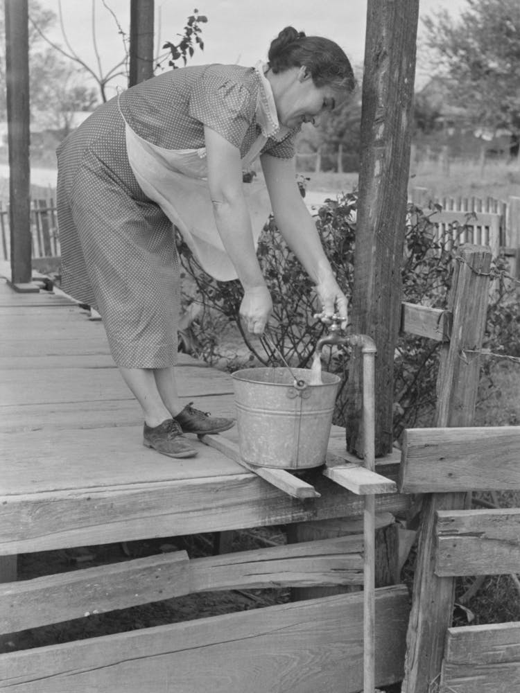 Wife Of Tenant Farmer Who Will Participate Under Tenant Purchase Drawing Water Near Morganza