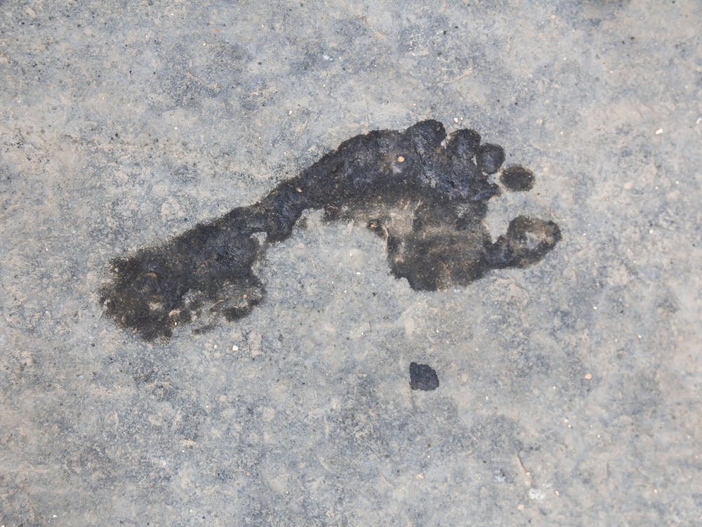 Wet Foot Print On A Rough Grungy Surface