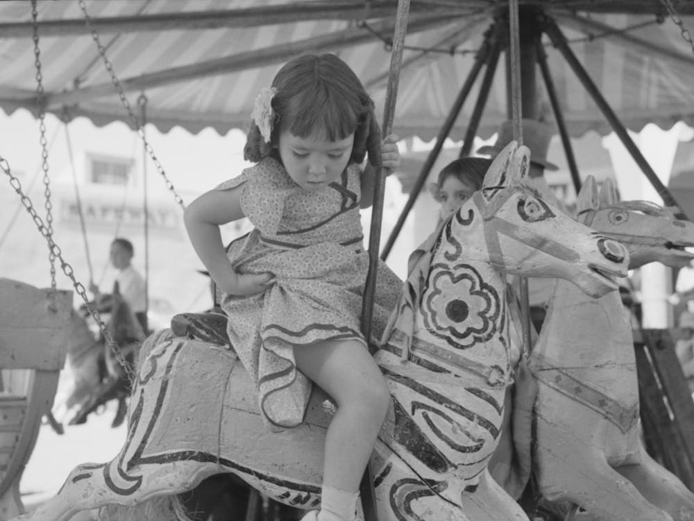 Little Girl On The Merry Go Round Horse, Fiesta, Taos, New Mexico By Russell Lee