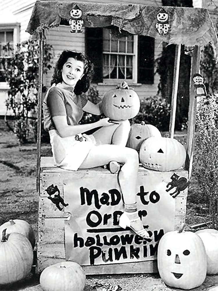 Pin Up Girl Pretending To Sell Carved Pumpkins