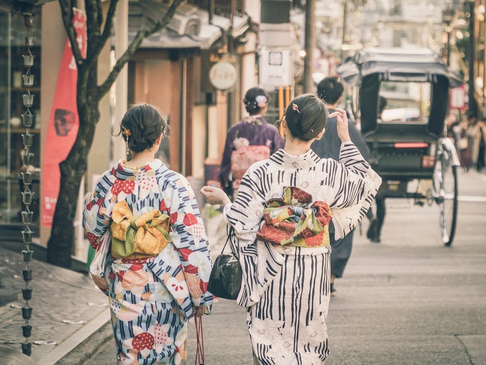 Two Japnese Women In Kimono Walking Down The Old Street of Kyoto