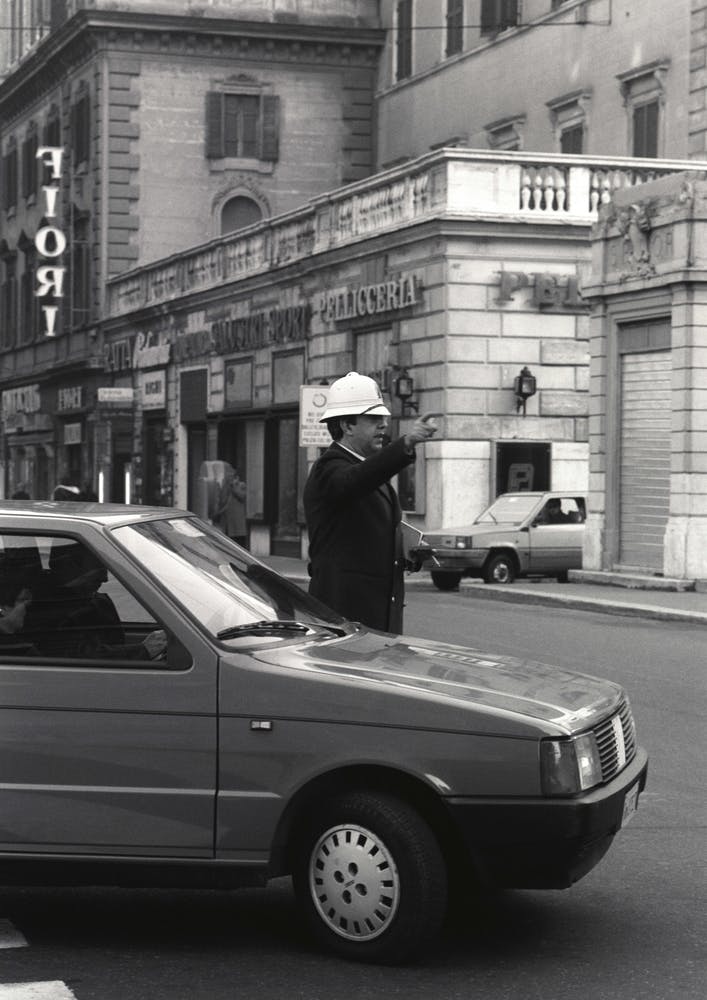 Policia Directing Traffic In Rome Black And White