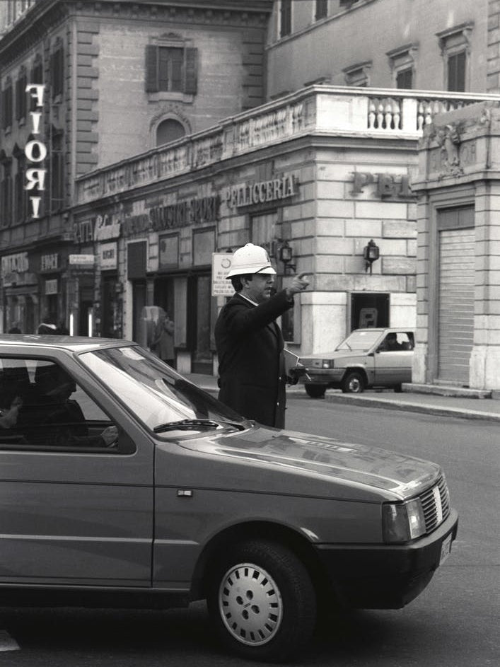 Policia Directing Traffic In Rome Black And White