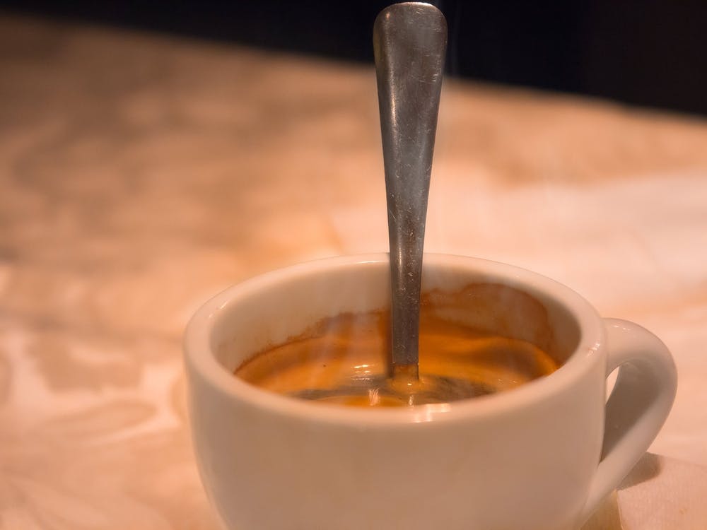 Cup Of Hot Coffee With Spoon In It With Smoke