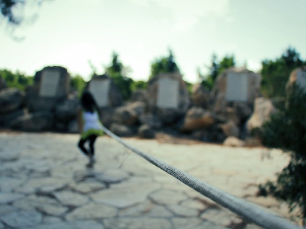 Young Girl Trying To Go Into The Distance As She Tied By A Rope