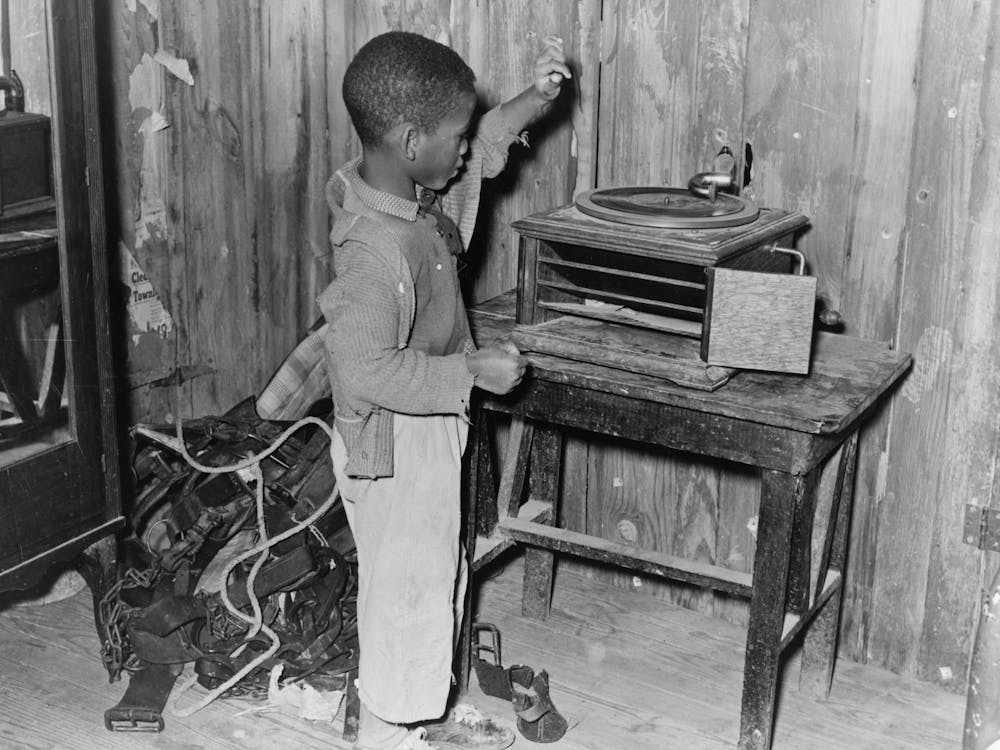 Child Playing Phonograph In Cabin Home, Transylvania Project, Louisiana By Russell Lee