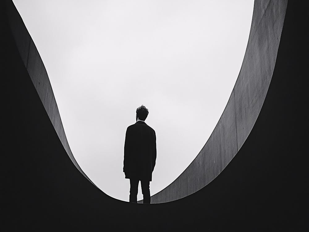 Man Standing On A Bridge