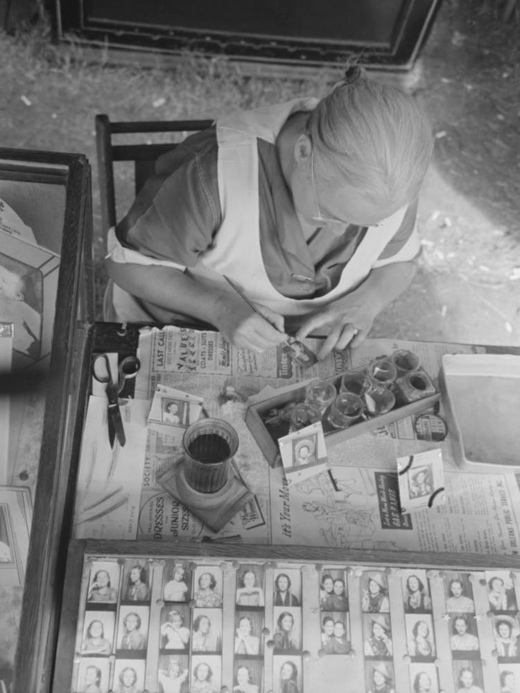 Wife Of Traveling Photographer Tinting Small Portraits, National Rice Festival, Crowley, Louisiana By Russell Lee