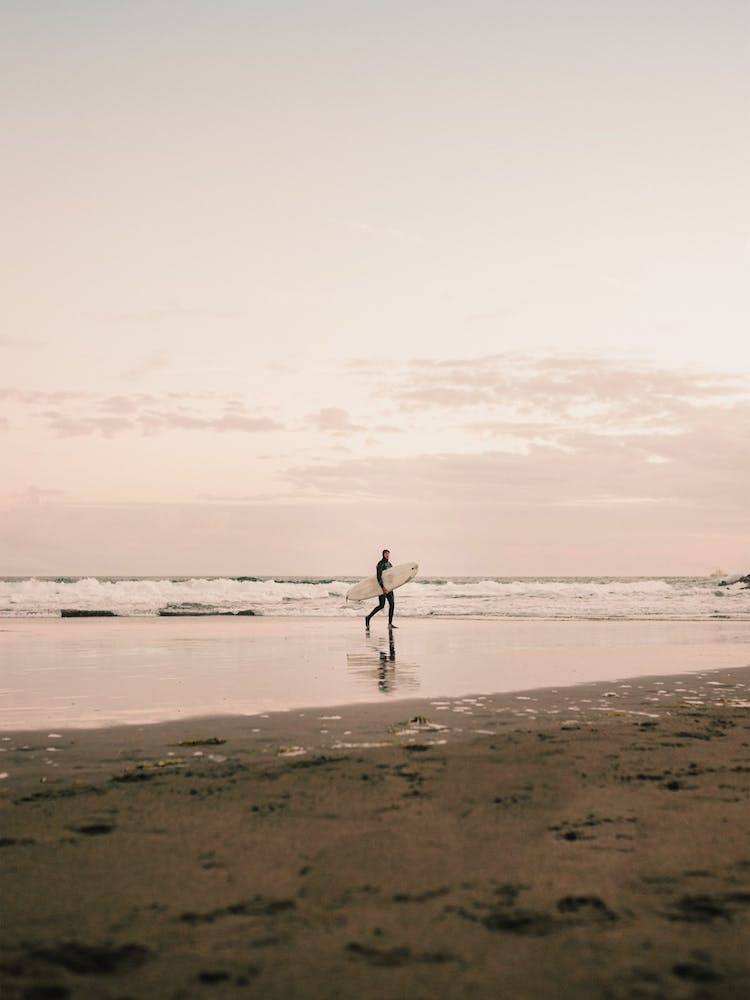 Surfer On Sunset Beach