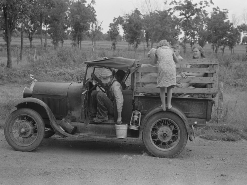 Migrant Getting Out Of Car With Pail To Get Some Water, Encamped Along Roadside Near Henrietta I E, Henryetta