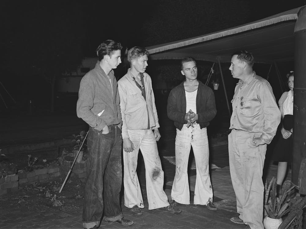 Three Boys Who Have Come Down From Los Angeles Looking For Work Talking To A Friend Who Is Already Employed