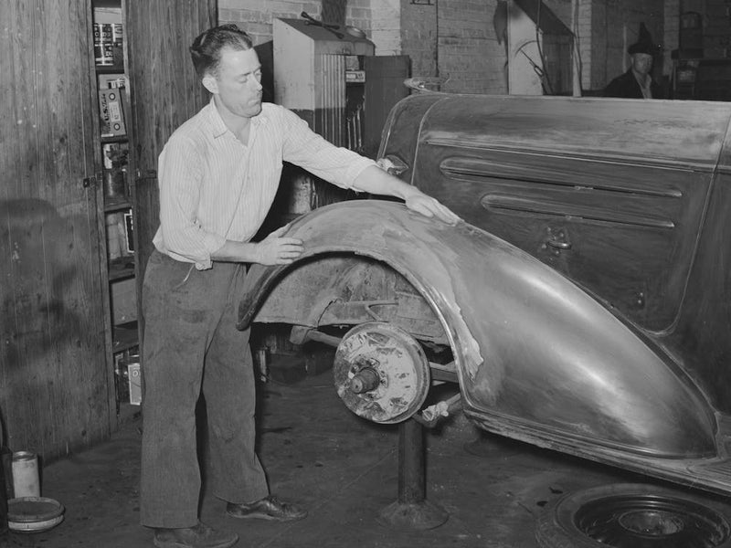 Refinishing Fender On Automobile In Garage, San Augustine, Texas By Russell Lee